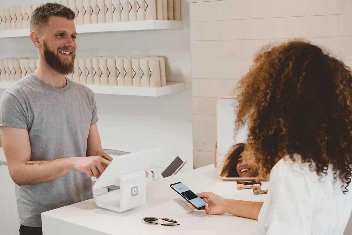Customer paying at a shop counter